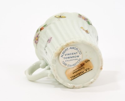 Lot 10 - An early Worcester coffee can, circa 1754-55, of elegant reeded form, with flared indented rim, bevelled base and scroll handle, painted with flowers and insects in the famille verte style, 5.5c...