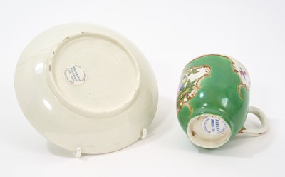 Lot 29 - A Worcester coffee cup and saucer, circa 1770, painted in coloured enamels with exotic birds, within gilt 'C' scroll cartouches, the apple-green ground with gilt scroll borders, panelled with sm...
