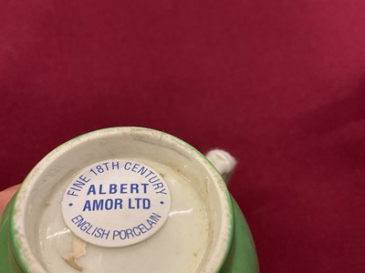 Lot 29 - A Worcester coffee cup and saucer, circa 1770, painted in coloured enamels with exotic birds, within gilt 'C' scroll cartouches, the apple-green ground with gilt scroll borders, panelled with sm...