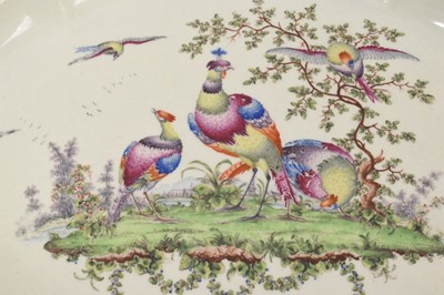 Lot 25 - A Worcester lobed dish with basketweave edge, circa 1772, polychrome painted with exotic birds, gilt dentil rim, 30cm diameter