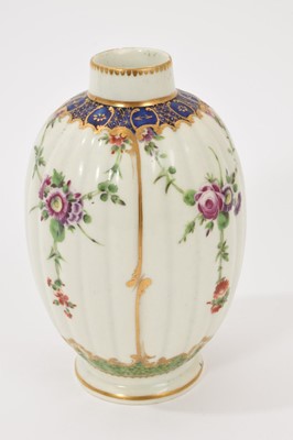 Lot 40 - A Worcester tea caddy, circa 1780, of fluted form, polychrome painted with floral swags in gilt panels, with a blue and gilt border, gilt dentil rim, the bottom with shagreen pattern, W mark to...