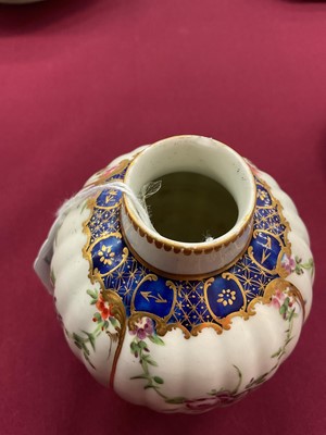 Lot 40 - A Worcester tea caddy, circa 1780, of fluted form, polychrome painted with floral swags in gilt panels, with a blue and gilt border, gilt dentil rim, the bottom with shagreen pattern, W mark to...