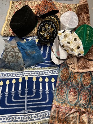 Lot 324 - Group of prayer mats, small rugs, Judaica and a selection of Eastern hats (2 boxes)