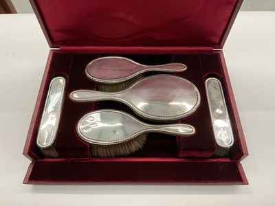 Lot 1028 - Garrard & Co. Silver five piece dressing table set in fitted red leather case