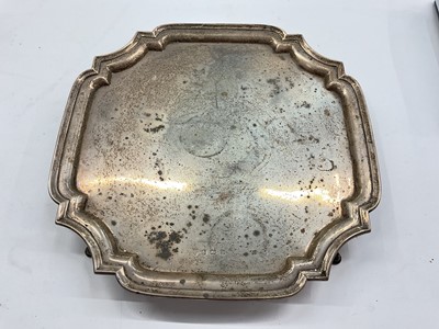 Lot 1075 - Silver salver of square form with canted corners and pie crust borders on four pad feet