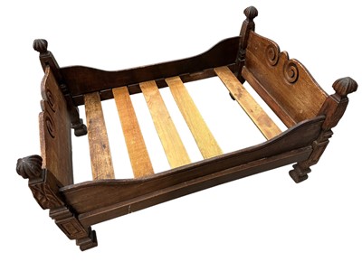 Lot 1417 - Antique wooden dolls bed with carved decoration