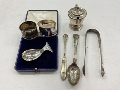 Lot 1139 - Group silver items to include two napkin rings, pair sugar tongs, mustard pots and flatware