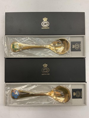 Lot 1125 - Two Georg Jensen Danish silver gilt and enamelled year spoons- 1982 and 1983, both sealed and boxed