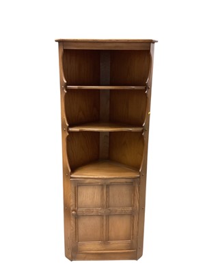 Lot 1313 - Ercol corner cupboard with open shelves and panelled door below, 75.5cm wide, 183.5cm high