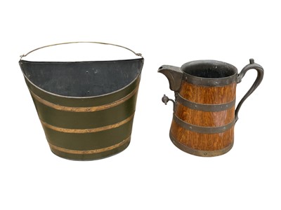 Lot 29 - Antique oak and brass bound milk jugs with branch form handle, together with a toleware pail (2)