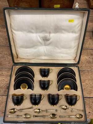 Lot 38 - Royal Worcester six person coffee set in case, decorated in black and gold, with gilt patterns to borders, with six silver gilt spoons hallmarked for 1919