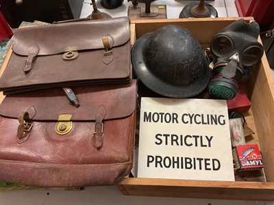 Lot 303 - Wooden box containing fishing reels, net etc, together two leather satchels, motor cycling sign, an air raid warden's helmet and gas mask