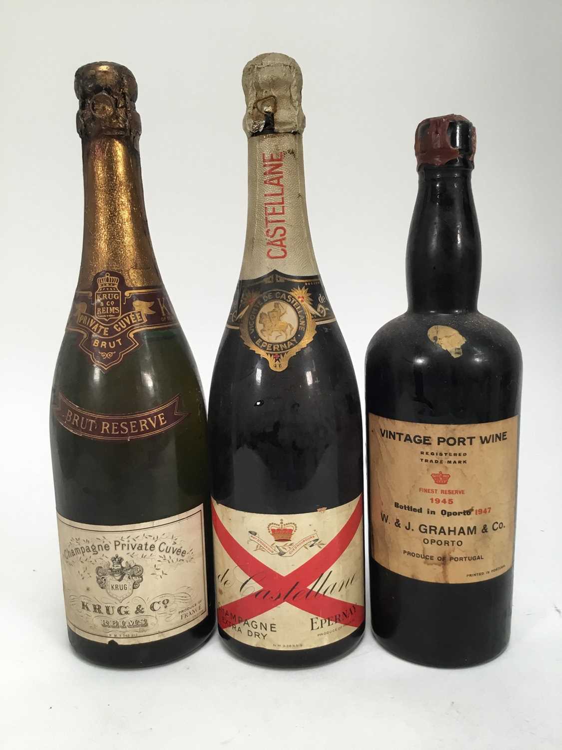 Lot 109 - Three bottles, Krug & Co brut reserve (low level), de Castellane champagne and a bottle of W & J Graham & Co. 1945 port, bottled 1947 (low level and leaking seal)