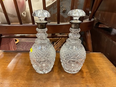 Lot 110 - Pair of cut glass decanters with silver collars