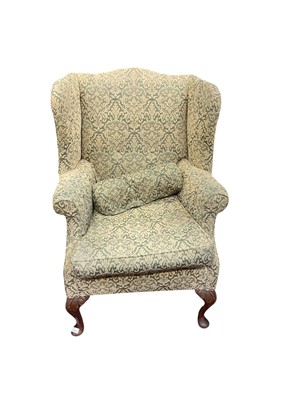 Lot 1374 - Georgian style wing back armchair with patterned green upholstery on carved cabriole front legs