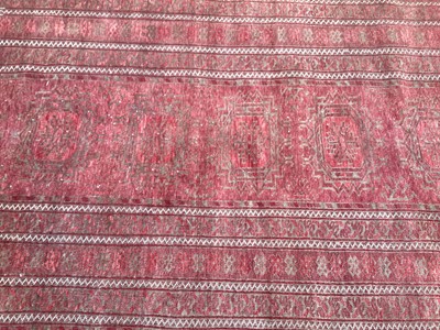 Lot 1427 - Eastern rug with geometric decoration on red ground, 210cm x 108cm