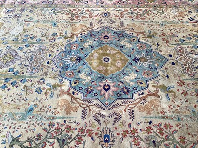 Lot 1432 - Large rug with central medallion and animal decoration on beige, blue and pink ground, 363cm x 272cm