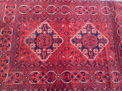 Lot 1435 - Eastern rug with two central medallions on red and blue ground, 130cm x 84cm