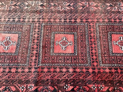 Lot 1437 - Eastern rug with three central medallions on red and black ground, 217cm x 122cm, together with two others, 210cm x 122cm and 193cm x 105cm plus a prayer mat (4)