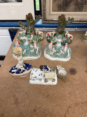 Lot 69 - Group of Staffordshire figures, including a rare group of a boy with rabbits and a hutch, circa 1840, a pair of pearlware sheep groups, another pair of sheep groups, a bird and nest, and a deer...