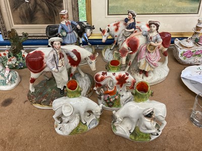 Lot 70 - Three pairs of Victorian Staffordshire cow and milkmaid groups, and other single figure (7)