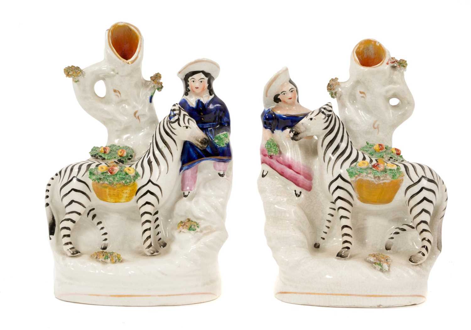 Lot 19 - Unusual pair of Staffordshire pottery zebra and child spill vases, circa 1860
