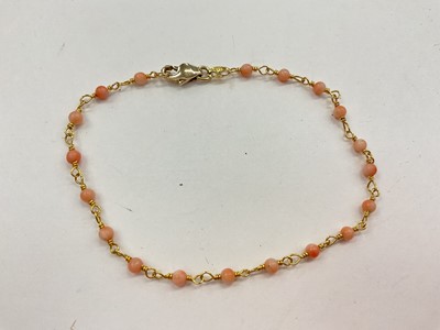 Lot 1170 - Gold and coral bead bracelet, 20cm long