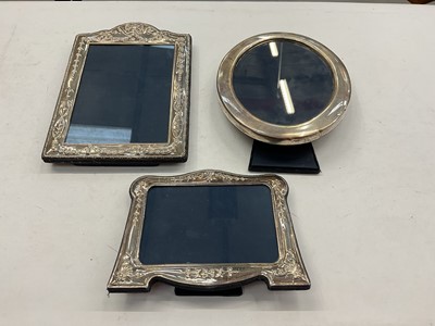 Lot 1171 - Mappin & Webb silver oval photograph frame (Sheffield 1986) and two other silver frames both with embossed floral scroll decoration (Sheffield 1992)