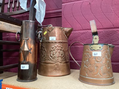 Lot 605 - Arts & Crafts copper ewer together with another similar and a Trench Art shell case vase with ring handles (3).