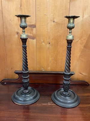 Lot 107 - Late 19th century pair of turned and carved mahogany candlesticks, with spiral and acanthus stems, brass sconces, 37cm high