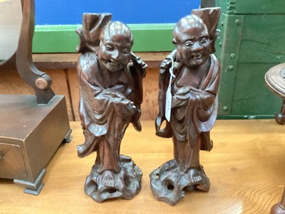 Lot 616 - Pair of Chinese carved wooden figures of immortals, each approximately 29.5cm in height.