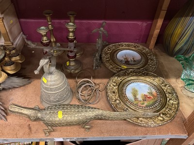 Lot 624 - Brass crocodile ornament, two pairs of brass candlesticks, pair of brass wall plaques with ceramic dishes and an bell.