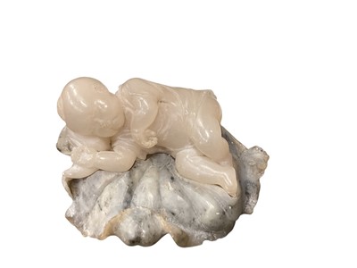 Lot 631 - Japanese carved soapstone figure of a sleeping baby on a lily.