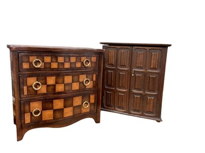 Lot 677 - Good quality contemporary miniature serpentine fronted chest of draws together with a carved oak smokers cabinet (2)