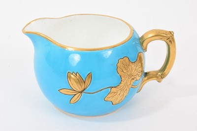 Lot 29 - Mintons Aesthetic style turquoise-ground pen tray decorated with insects and a stylised ribbon pattern, and a milk jug with lotus flowers in gilt relief