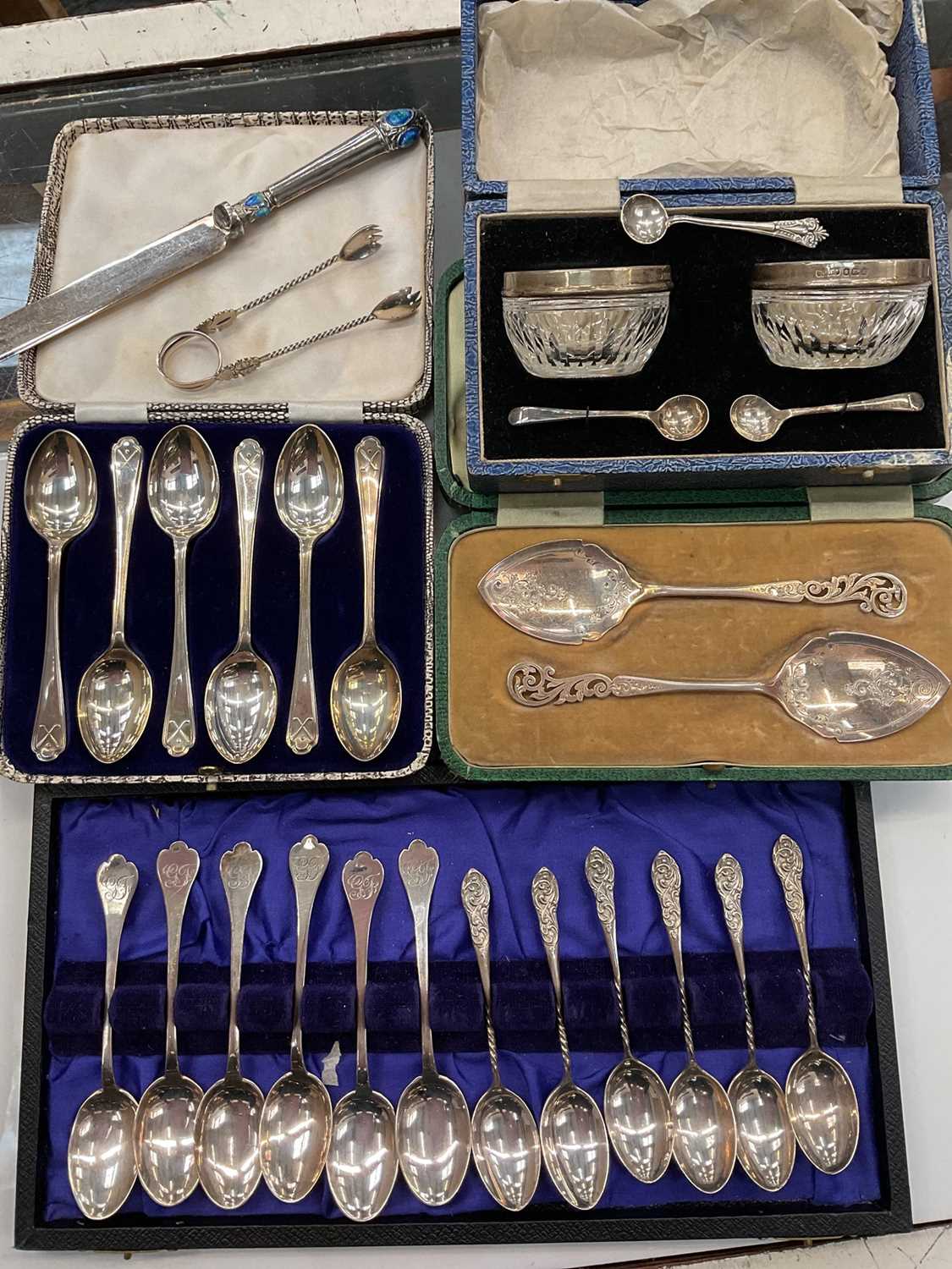 Lot 1054 - Three sets of six silver teaspoons, pair of silver mounted glass salts and salt spoons in fitted case, pair of silver spoons, together with plated flatware