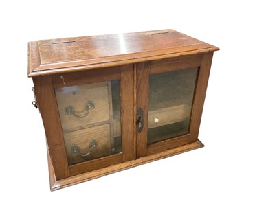 Lot 743 - Early 20th century smokers cabinet enclosed by pair of glass doors.