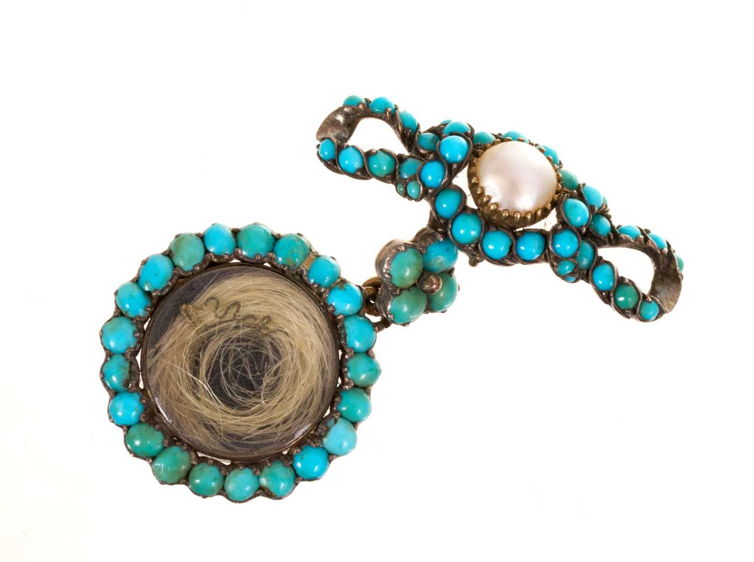 Lot 19th century turquoise and pearl pendant locket with a circular locket suspended from a bow brooch, the reverse with further compartment and inscription "H.R.H. Mary Duchess of Gloucester, 1857"...