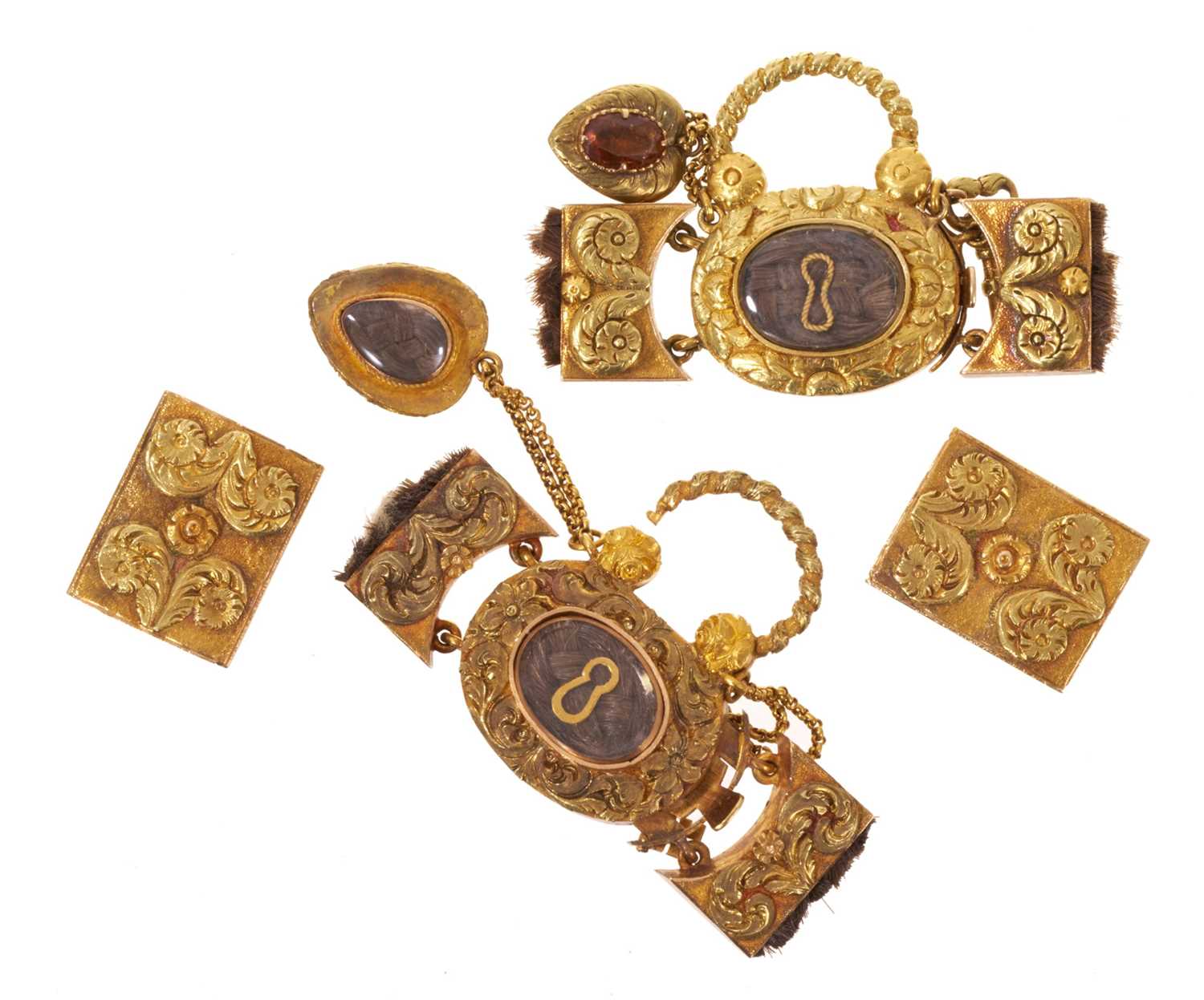 Lot A fine quality pair of Regency gold mourning bracelet clasps, each designed as a padlock with glazed components containing plaited hair and suspending a gold key and heart-shaped pendant drop wi...