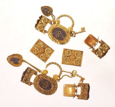 Lot A fine quality pair of Regency gold mourning bracelet clasps, each designed as a padlock with glazed components containing plaited hair and suspending a gold key and heart-shaped pendant drop wi...