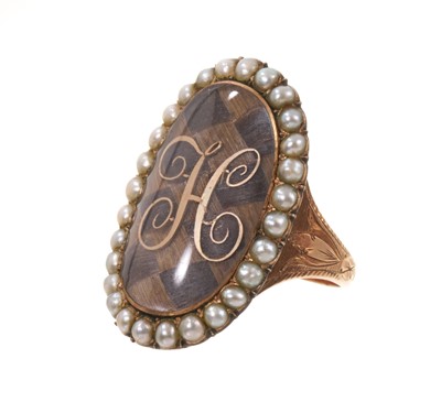 Lot George III gold and seed pearl mourning ring with a large oval glazed bezel containing a finely woven hair chequered panel surmounted by a gold initial 'H', surrounded by a seed pearl border, en...