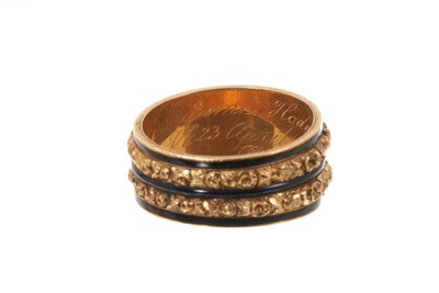 Lot George III gold and enamel mourning ring, the wide band with glazed compartment of hair on a double row of foliate gold bands with black enamel borders, inscribed "James Hodgson ob. 23rd April 1...