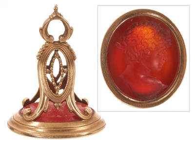 Lot Georgian gold seal with an oval intaglio carved carnelian depicting a young classical Roman male bust in profile, in a gold mount, 34mm.