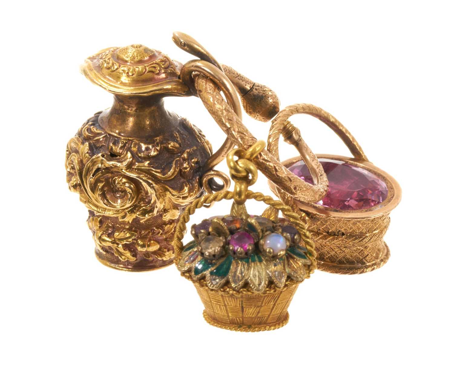 Lot Three Regency novelty charms/seals, to include a yellow metal multi-gem and enamel basket, another yellow metal basket with foil-backed pink stone and intaglio seal with Cupid, and a yellow meta...