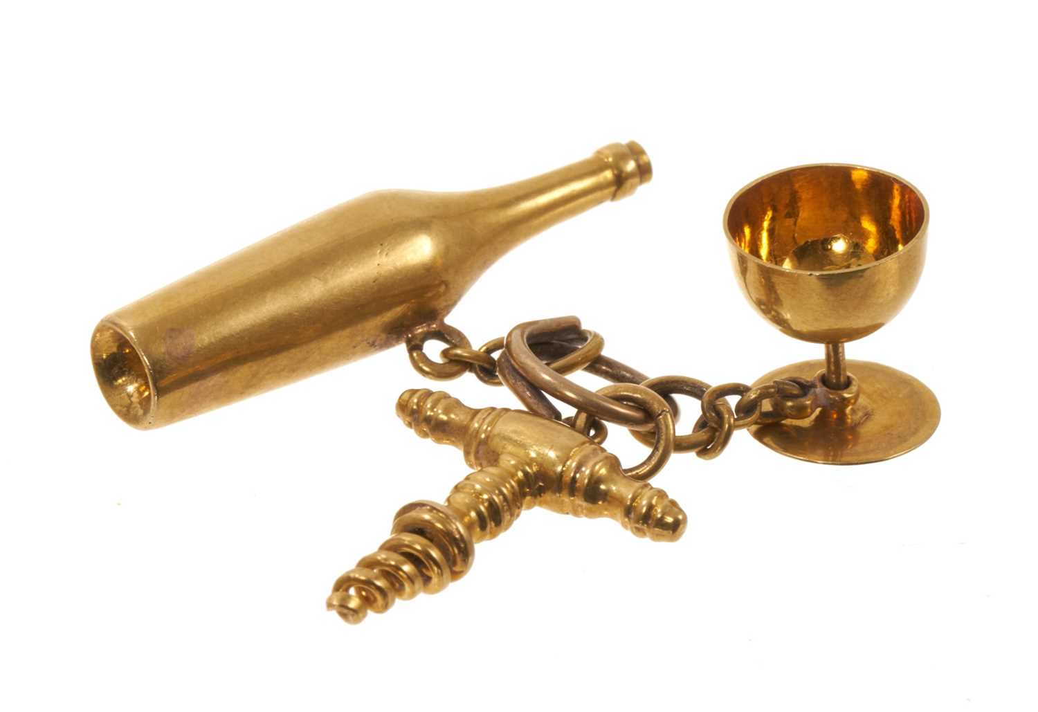 Lot Antique French gold novelty charm in the form a wine bottle, corkscrew and goblet, French eagle's head hallmarks.