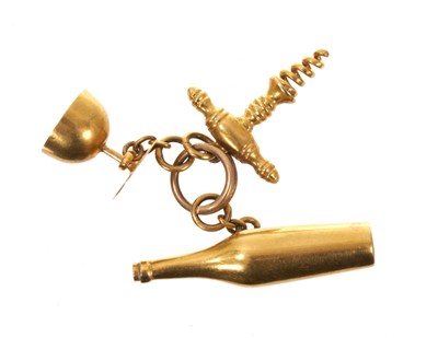 Lot Antique French gold novelty charm in the form a wine bottle, corkscrew and goblet, French eagle's head hallmarks.