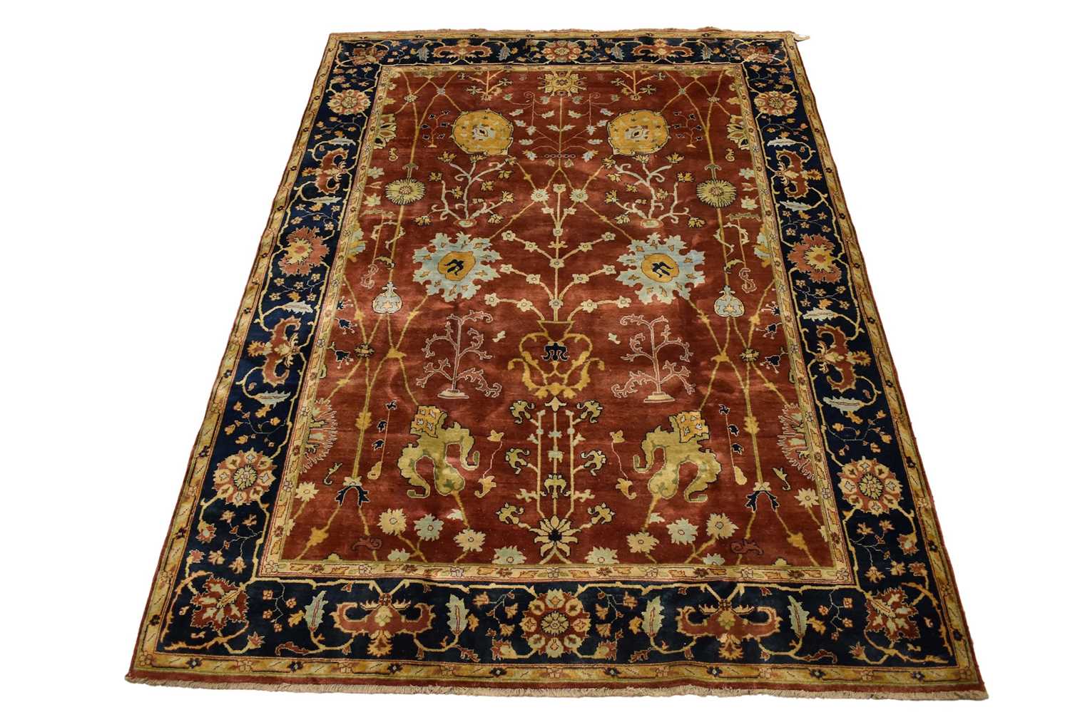 Lot 1742 - Good Indian Agra carpet, with broad lotus flower design on brick red ground, in main foliate meander border, 343 x 254cm