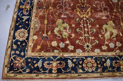 Lot 1742 - Good Indian Agra carpet, with broad lotus flower design on brick red ground, in main foliate meander border, 343 x 254cm
