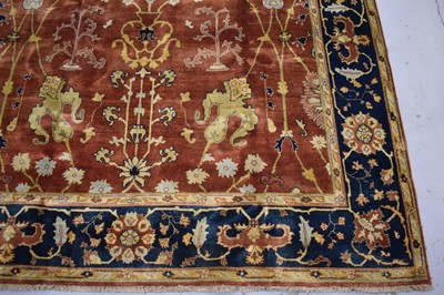 Lot 1742 - Good Indian Agra carpet, with broad lotus flower design on brick red ground, in main foliate meander border, 343 x 254cm
