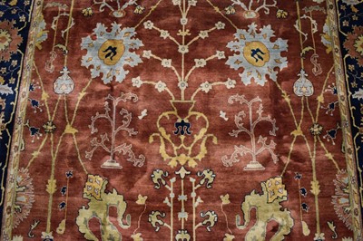 Lot 1742 - Good Indian Agra carpet, with broad lotus flower design on brick red ground, in main foliate meander border, 343 x 254cm